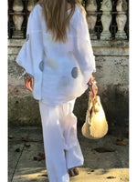 Two-piece Set Featuring A Loose, Casual Polka-dot Print Linen-cotton Top And White Trousers.